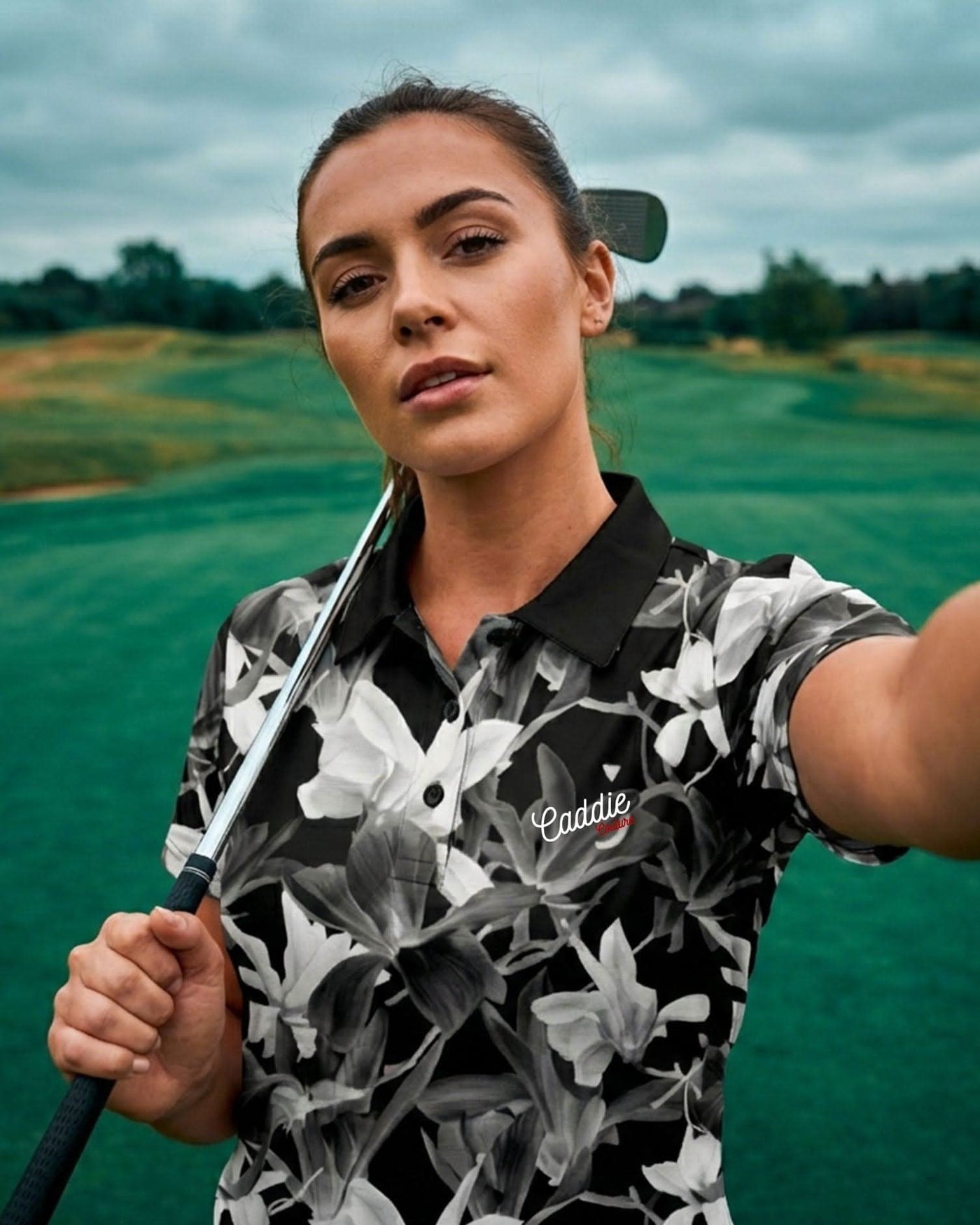 Woman holding a golf club on a golf course
