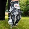 Golf glove and ball on a tee with a blurred green background