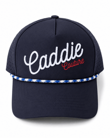 Navy blue cap with 'Caddie Couture' text on a white background