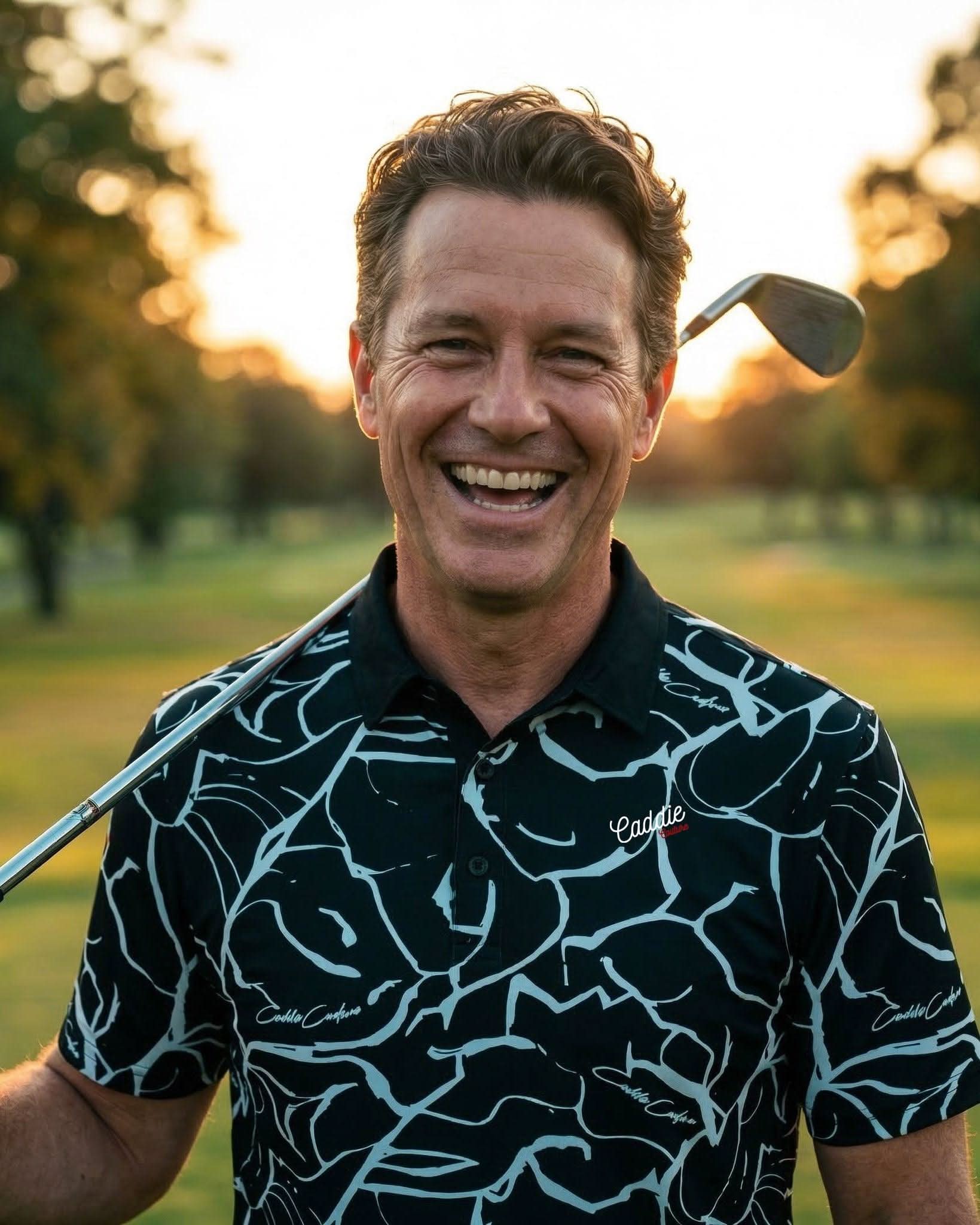 Man holding a golf club on a golf course with a blurred background