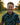 Man holding a golf club on a golf course with a blurred background
