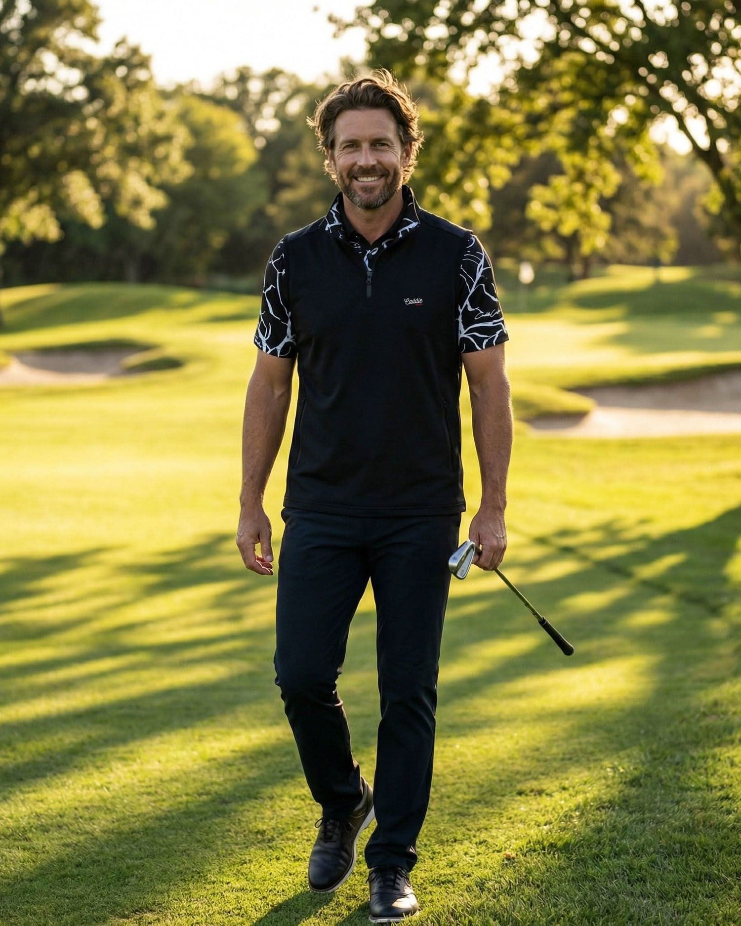 Man walking on a golf course holding a golf club