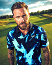 Man wearing a blue patterned shirt on a golf course