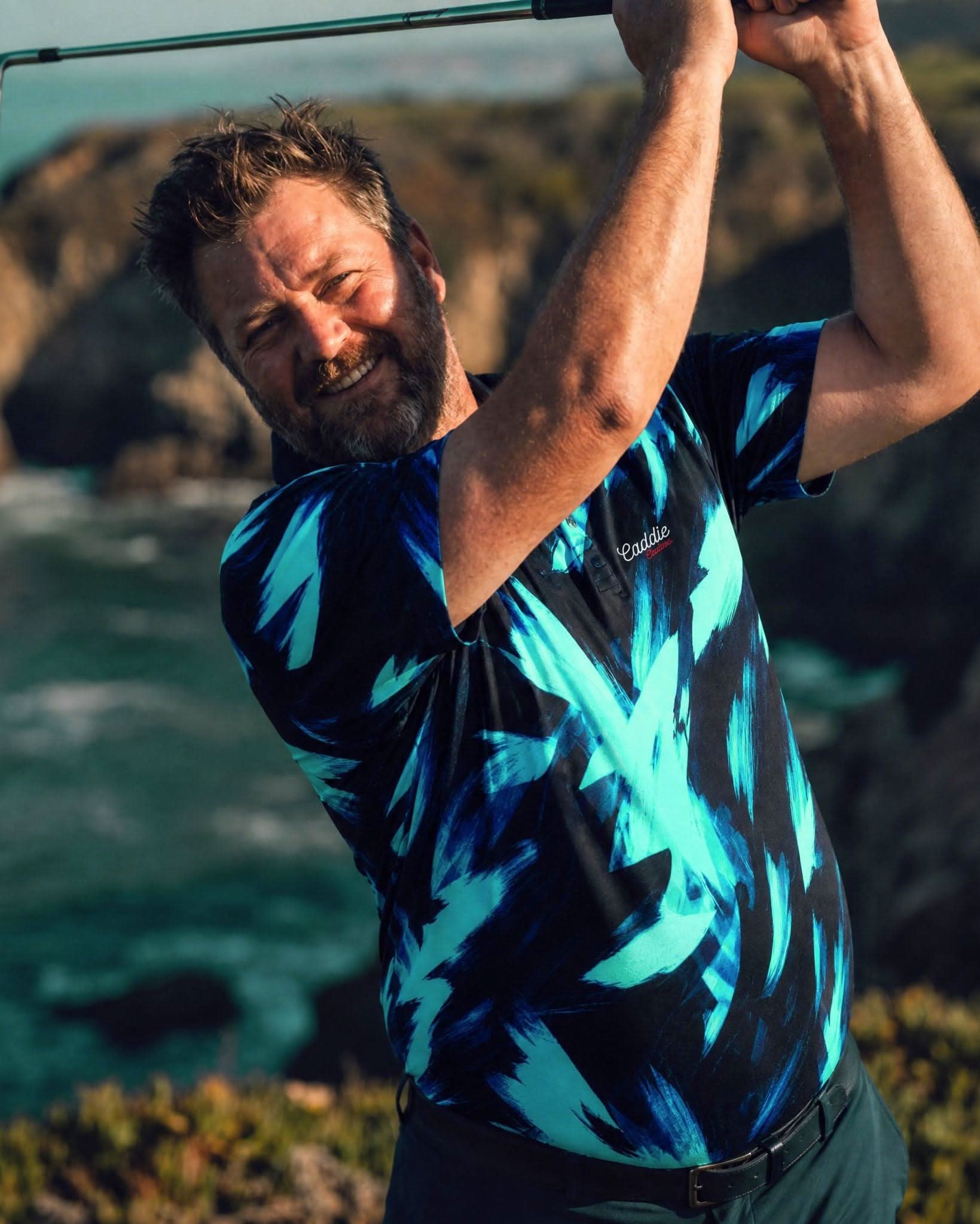 Man playing golf with a scenic ocean and cliffs in the background