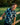 Young boy in a patterned shirt standing by a wooden fence with a blurred green background