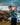 Young boy playing golf on a coastal cliff with ocean and sky in the background