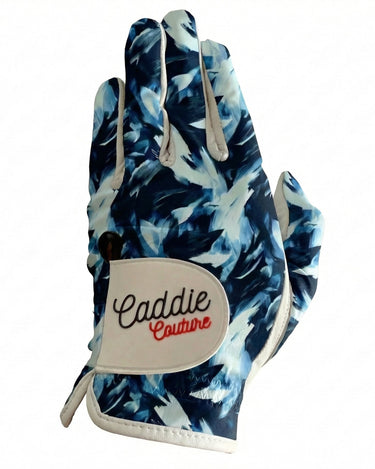 Golf glove with blue floral pattern and 'Caddie Couture' branding on a white background