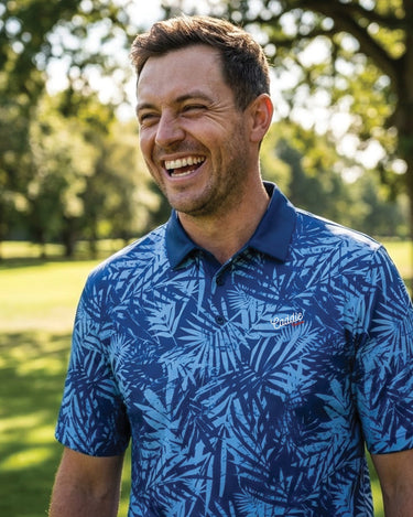 Man wearing a blue patterned shirt in a park setting