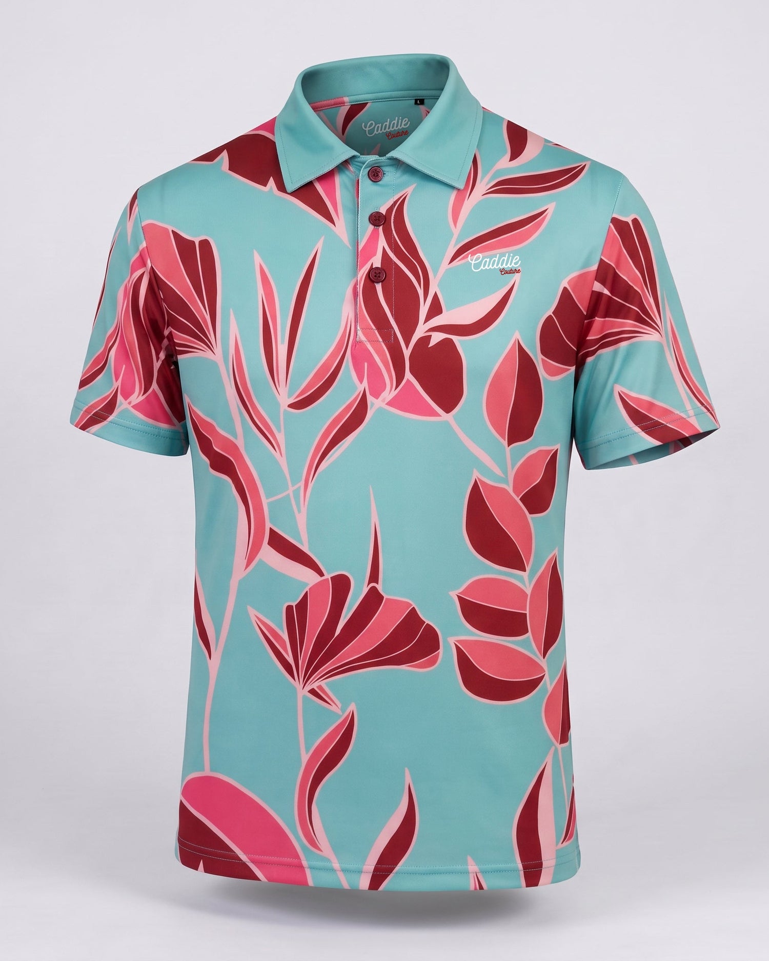 A short-sleeve polo shirt with a vibrant turquoise blue base and a bold pink and red floral pattern, displayed on a neutral light gray background.