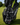 Golf bag with a black and white golf towel featuring 'Caddie' branding on a grassy background.