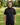 Man wearing a black hoodie with a logo on a golf course
