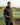 Man standing on a golf course with scenic background