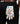 Colorful patterned glove with 'Caddie Couture' label held in front of black pants.