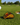 Taco-shaped golf marker on a golf course with a golf ball and hole in the background.