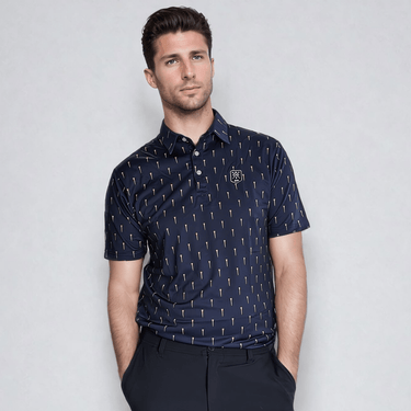A man wearing a navy blue golf polo with a pattern of golf tees.