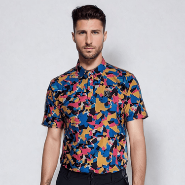 A man wearing a short-sleeved multicolor geometric patterned golf polo shirt.