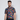 A man wearing a short-sleeved multicolor geometric patterned golf polo shirt.