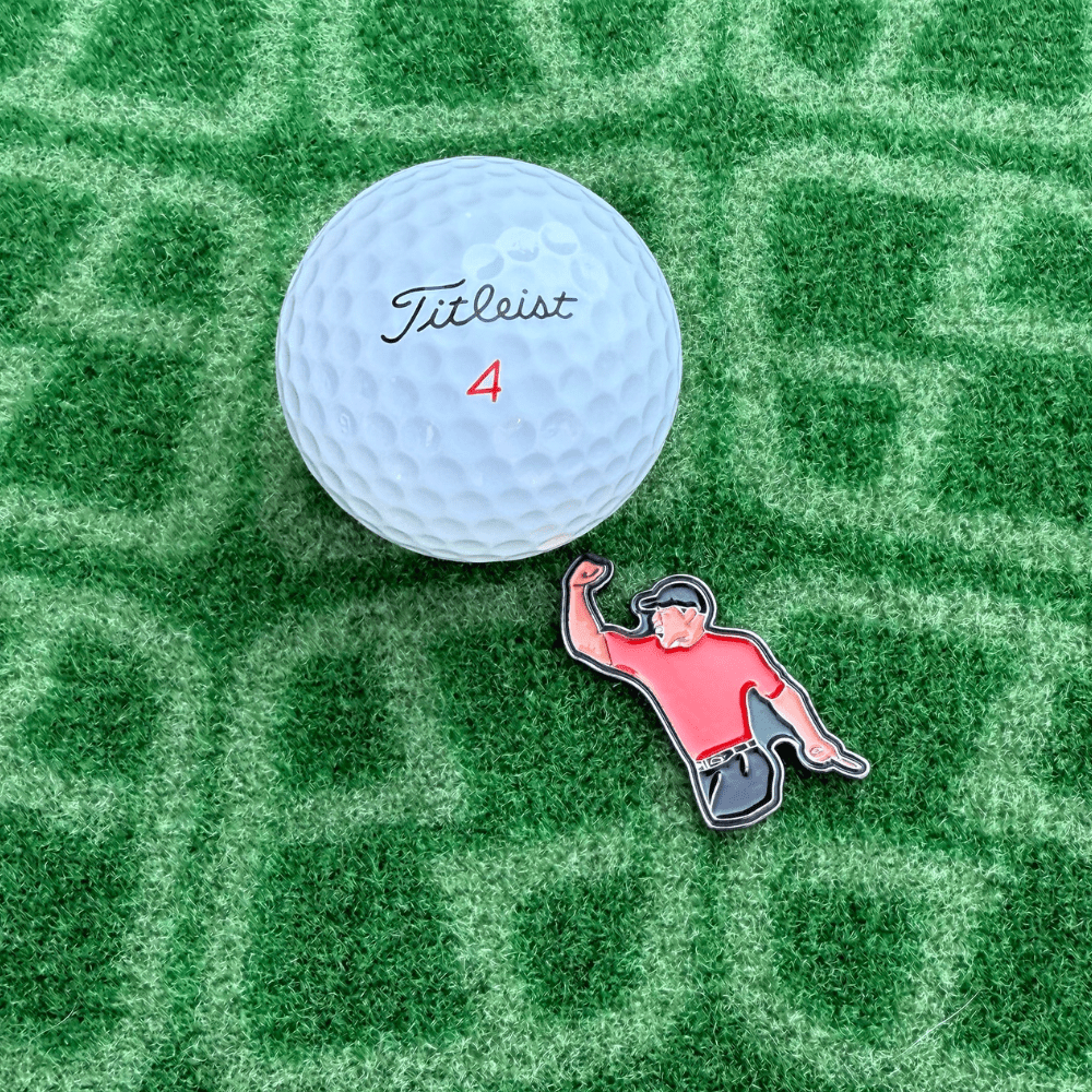 Tiger Woods Golf Ball Marker next to golf ball