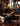 Man sitting on a leather couch in a stylish room with trophies and decor.