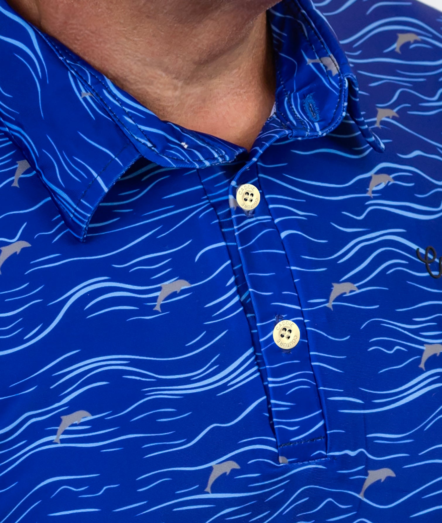 Close-up of a blue patterned golf shirt with white buttons