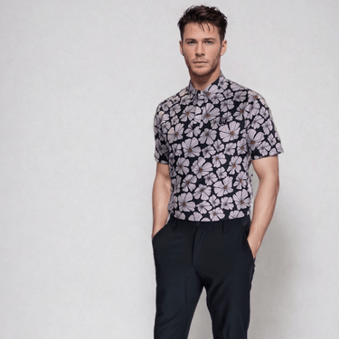 man wearing floral golf polo with hands in pockets