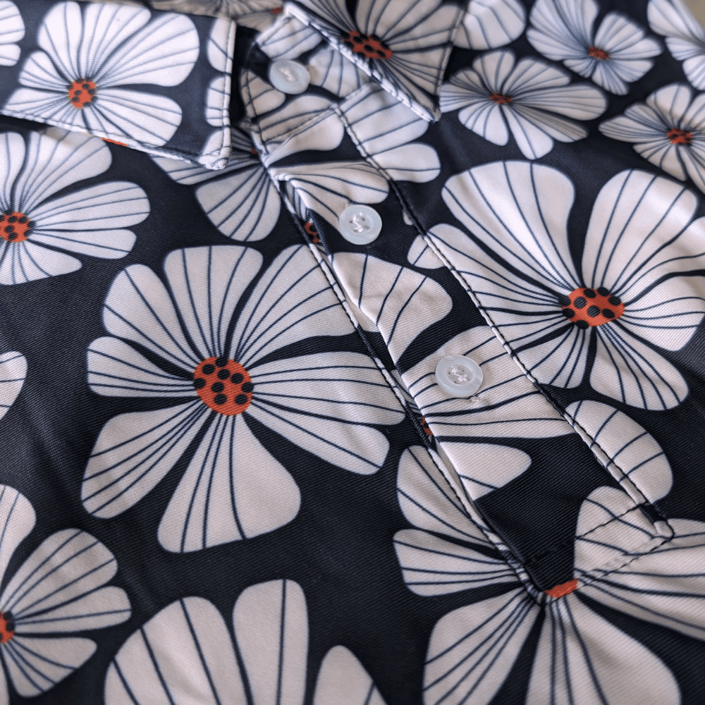 close up picture of floral golf polo