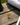 Small trophy-shaped object on a wooden surface with Augusta National Golf Club hat in the background